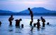 Burma / Myanmar: Bathing and swimming in the Irrawaddy / Ayeyarwady River at dusk near Mandalay